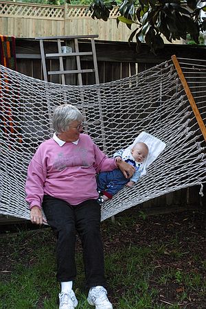 Grandma rocks Zeke in the hammock.