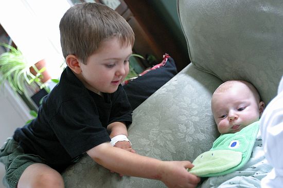 Wyatt squeezes Gus's bib.