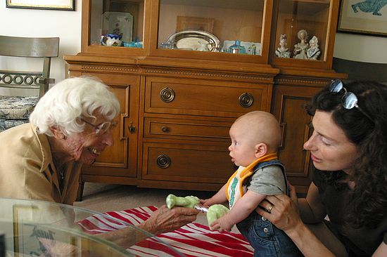 Great Grandma Sara entertains Zeke while Amy looks on.