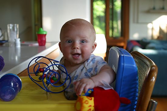 Gus tries out the booster chair.