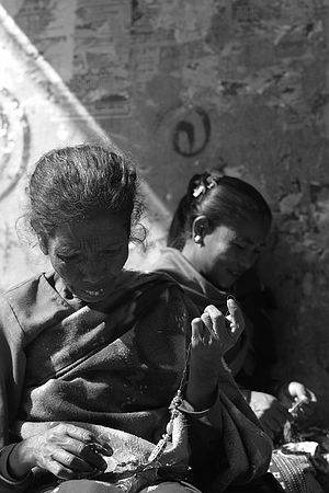 Stringing beads on the streets.