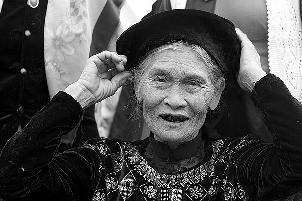 Adjusting her hat.