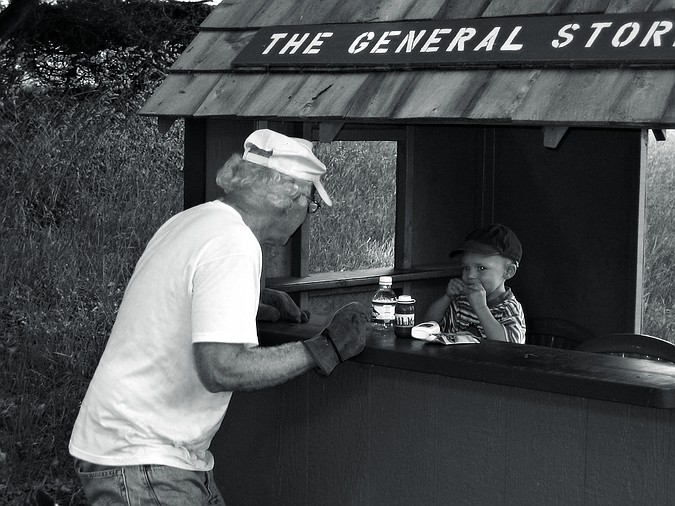 Gus tastes the wares at the general store.